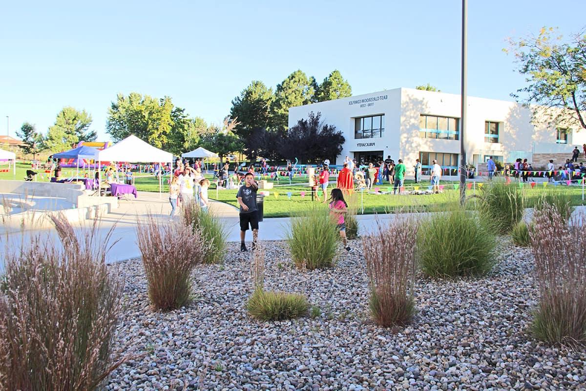 Families enjoy games on the lawn at Learning Commons Plaza.