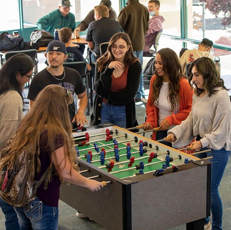 San Juan College students playing foosball in the Suns Student Lounge.